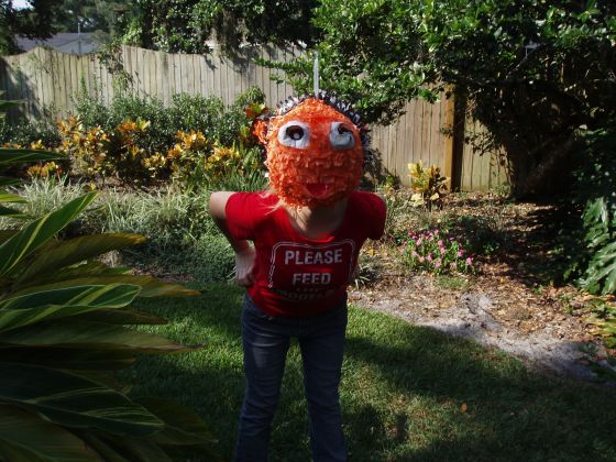 Somethigns fishy...
Ally tries on the pinata face but it dosent look quite right... since when do fish have legs?

