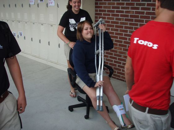 Amanda on crutches
Amanda being rolled around by Julia in a chair to save her feet from the hard work; while they were doing this they actually passed another guy that had broken his foot
