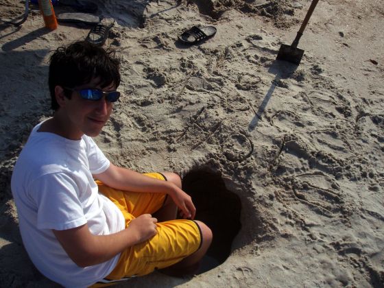 James hole 2
James with his feet in the hole we dug at the beach
