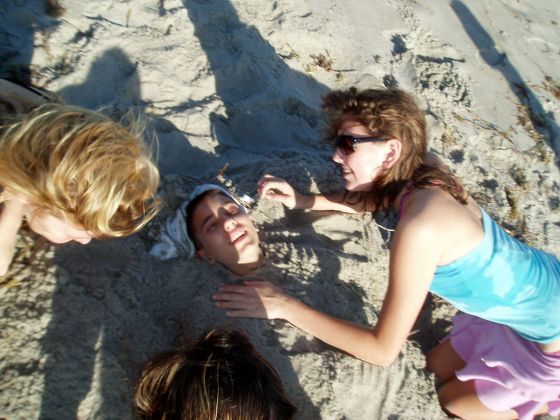 Nathan buried
Nathan being buried by Ally and Brittany at the beach party
