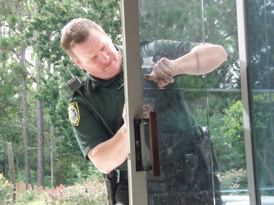 Police officer inspecting 2
The same officer checking a door for fingerprints
