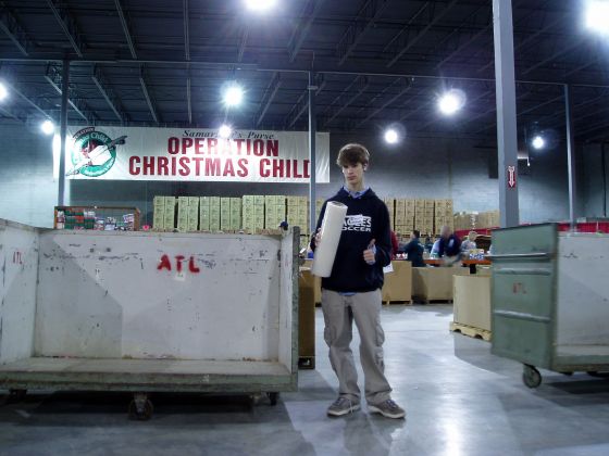 Michael in the warehouse
Michael posing with the saranwrap that we used to keep all of the bulging boxes together at the Operation Christmas Child warehouse
